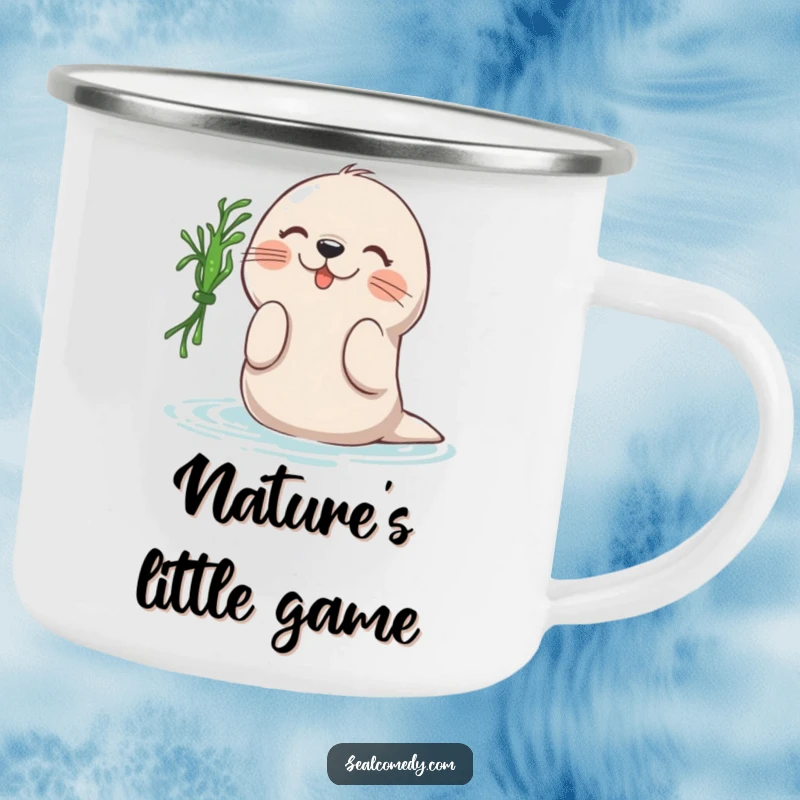 Funny camping mug depicting a seal playfully battting at a piece of seaweed, a humorous and durable companion for outdoor excursions.