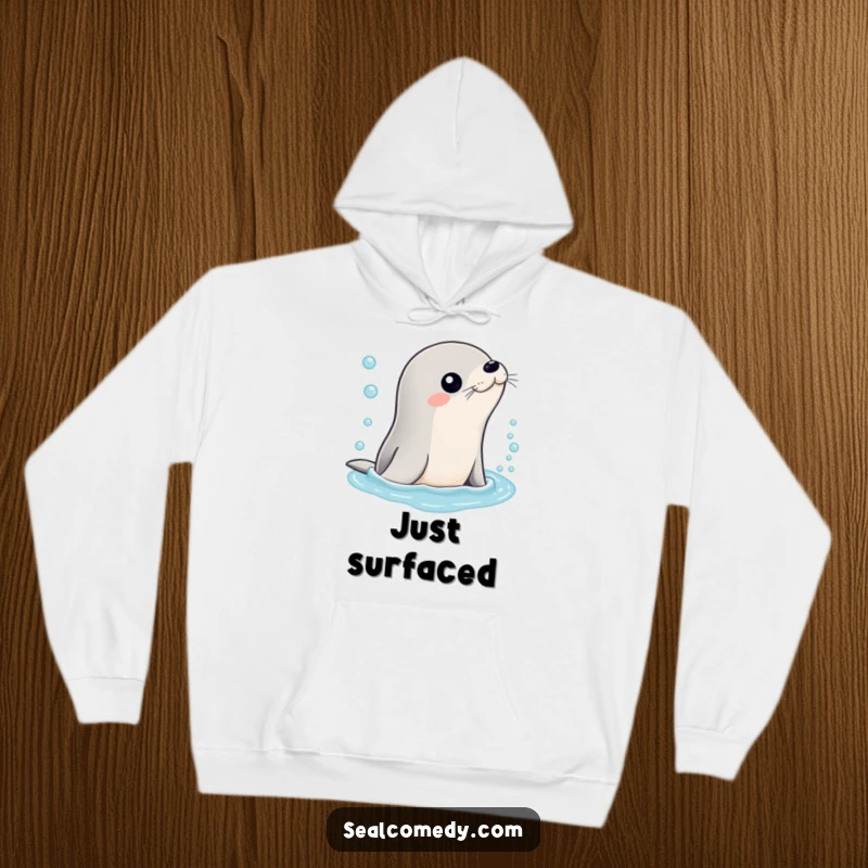 Funny hoodie featuring a sleek seal character emerging from bubbly water, offering warmth and a refreshing, humorous vibe.