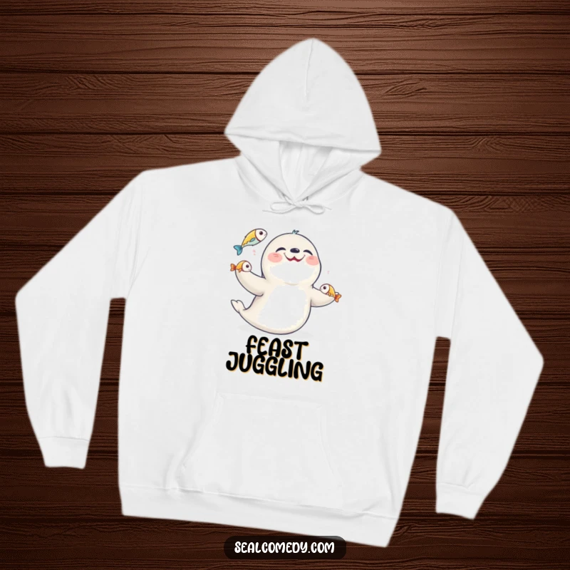 Funny giggling seal juggling fish, depicted on a soft, warm hoodie, ideal for casual wear and humor.
