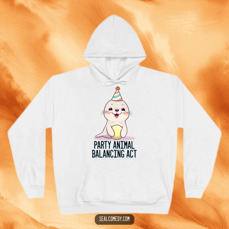 Funny seal pup wearing a party hat, balancing a ball, making this cozy hoodie a celebration of adorable silliness.